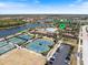 Community center featuring tennis courts, pool, and parking, nestled in a scenic lakeside setting at 20655 Valprato Ct, Venice, FL 34293