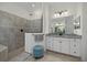Elegant bathroom features granite countertops, a large mirror, and glass-enclosed walk-in shower at 20655 Valprato Ct, Venice, FL 34293