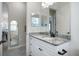 This bathroom has a bright white vanity and a full wall mirror at 20655 Valprato Ct, Venice, FL 34293