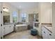 Bright bathroom featuring a soaking tub, double vanity, and refined tile work at 20655 Valprato Ct, Venice, FL 34293