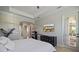 Bright bedroom boasts a view of the lanai, tray ceilings, and an en-suite bathroom for ultimate privacy at 20655 Valprato Ct, Venice, FL 34293