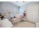 This bedroom is bright and airy with a modern playhouse bed and ample closet space at 20655 Valprato Ct, Venice, FL 34293