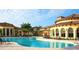Resort-style community pool with ample seating and shaded areas surrounded by lush landscaping at 20655 Valprato Ct, Venice, FL 34293