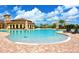 Expansive community pool featuring comfortable lounge chairs and umbrellas for a relaxing experience at 20655 Valprato Ct, Venice, FL 34293