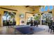 Community room with ping pong table, fireplace, ceiling fans, and comfortable outdoor seating at 20655 Valprato Ct, Venice, FL 34293