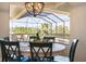 Dining area with round table, chairs, light fixture, and a view of the pool at 20655 Valprato Ct, Venice, FL 34293