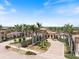 The community entrance features decorative arches, a brick drive, and manicured lawns at 20655 Valprato Ct, Venice, FL 34293