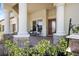 Charming front porch adorned with stone accents and ample seating at 20655 Valprato Ct, Venice, FL 34293