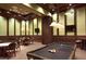 Community game room with pool table, accent lighting, mounted televisions, and several tables at 20655 Valprato Ct, Venice, FL 34293