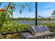 Stainless steel grill with an outdoor view of lush greenery and a lake perfect for backyard barbecues at 20655 Valprato Ct, Venice, FL 34293