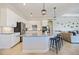 Bright kitchen with white cabinets, granite countertops, stainless steel appliances, and an island with bar seating at 20655 Valprato Ct, Venice, FL 34293