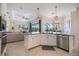 Kitchen featuring a corner sink, stainless steel dishwasher, granite counters, and an open floorplan at 20655 Valprato Ct, Venice, FL 34293