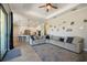 Open concept living space adjacent to the kitchen with barstool seating and a large sectional sofa at 20655 Valprato Ct, Venice, FL 34293