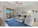 This living room features a cozy seating arrangement and a large sliding glass door that leads to the outside at 20655 Valprato Ct, Venice, FL 34293