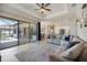 A large sectional sofa is featured in this living room that is connected to a modern kitchen with a center island at 20655 Valprato Ct, Venice, FL 34293