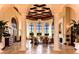 Community lobby featuring marble floors, stately columns, coffered ceiling, and seating at 20655 Valprato Ct, Venice, FL 34293