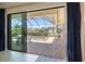 Enjoy outdoor living with a screened-in lanai overlooking a private pool and lush landscaping, accessible from the living room at 20655 Valprato Ct, Venice, FL 34293