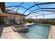 Backyard screened-in pool features a hot tub and plenty of space for lounge chairs and outdoor furniture at 20655 Valprato Ct, Venice, FL 34293