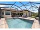 A sparkling pool and spa are surrounded by a screened lanai, perfect for outdoor entertaining and relaxation at 20655 Valprato Ct, Venice, FL 34293