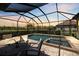 Enjoy outdoor living with a screened pool, spa, and landscaped backyard at 20655 Valprato Ct, Venice, FL 34293