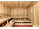 Relaxing sauna room with wooden benches, walls, and ceiling creating a cozy atmosphere at 20655 Valprato Ct, Venice, FL 34293