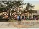Picturesque town square features a large shade tree illuminated with decorative lighting and a water feature at 20655 Valprato Ct, Venice, FL 34293