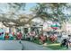 Spacious town square for community events and gatherings featuring ample seating under a mature oak tree at 20655 Valprato Ct, Venice, FL 34293