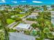 Stunning aerial view of a coastal community with lush landscaping, beautiful homes, and ocean views at 216 Palmetto Ave, Anna Maria, FL 34216