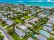 Aerial view of homes in a beautiful residential area near the ocean, featuring lush landscaping at 216 Palmetto Ave, Anna Maria, FL 34216