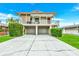 Charming two-story home featuring a covered balcony, two-car garage, and well-manicured lawn at 216 Palmetto Ave, Anna Maria, FL 34216