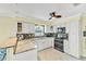 Modern kitchen with granite countertops, stainless steel appliances, tiled backsplash, and white cabinetry at 216 Palmetto Ave, Anna Maria, FL 34216