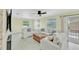 Inviting living room with light walls, white sofas, ceiling fan, and sliding glass doors leading to an outdoor space at 216 Palmetto Ave, Anna Maria, FL 34216