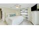 Relaxing bedroom with a white bed, dresser, ceiling fan, soft lighting, and soothing color scheme at 216 Palmetto Ave, Anna Maria, FL 34216