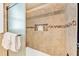Tiled shower with decorative mosaic stripe and recessed shelving for toiletries at 216 Palmetto Ave, Anna Maria, FL 34216