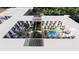 Aerial view of a modern residential complex with a central courtyard featuring a pool and lush landscaping at 2170 Robinhood St # A1-304, Sarasota, FL 34231