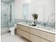 Bright bathroom with a double sink vanity, glass shower, and modern fixtures at 2170 Robinhood St # A1-304, Sarasota, FL 34231