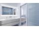 Modern bathroom featuring a double vanity with gray wood cabinets and blue tiled walls at 2170 Robinhood St # A1-304, Sarasota, FL 34231