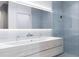 Modern bathroom with light-blue tiling, dual sink vanity, and a glass-enclosed shower at 2170 Robinhood St # A1-304, Sarasota, FL 34231