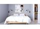 Contemporary bedroom showcasing soft gray walls, art, bedside lighting and a large walk-in closet at 2170 Robinhood St # A1-304, Sarasota, FL 34231