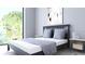 Modern bedroom with a view overlooking lush greenery, accentuated by a sleek bed frame and minimalist decor at 2170 Robinhood St # A1-304, Sarasota, FL 34231