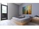 A modern bedroom featuring a low platform bed, minimalist decor, and lots of natural light at 2170 Robinhood St # A1-304, Sarasota, FL 34231