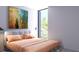 Bedroom featuring a king bed, neutral colors, art, and a wall of windows with lush outdoor views at 2170 Robinhood St # A1-304, Sarasota, FL 34231