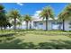 Modern building exterior featuring palm trees, lush green landscaping, and contemporary architectural design at 2170 Robinhood St # A1-304, Sarasota, FL 34231