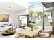 Inviting living room featuring contemporary lighting, stylish furniture, and an outdoor dining area visible through expansive windows at 2170 Robinhood St # A1-304, Sarasota, FL 34231