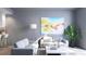 Cozy living room featuring modern decor, neutral tones, and an abstract painting on the wall at 2170 Robinhood St # A1-304, Sarasota, FL 34231