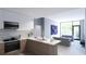 Open-concept living space with modern kitchen featuring stainless steel appliances and ample counter space at 2170 Robinhood St # A1-304, Sarasota, FL 34231