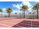 Outdoor tennis court surrounded by palm trees, providing a beautiful and recreational amenity at 2170 Robinhood St # A1-304, Sarasota, FL 34231