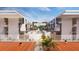 Exterior image showcasing modern apartments with a shared tennis court and pathway at 2170 Robinhood St # A1-304, Sarasota, FL 34231