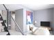 Cozy living area featuring modern staircase, a comfortable chair, and stylish decor at 2170 Robinhood St # A2-305, Sarasota, FL 34231