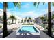 Outdoor pool with lounge chairs surrounded by modern architecture and lush landscaping at 2170 Robinhood St # A2-305, Sarasota, FL 34231